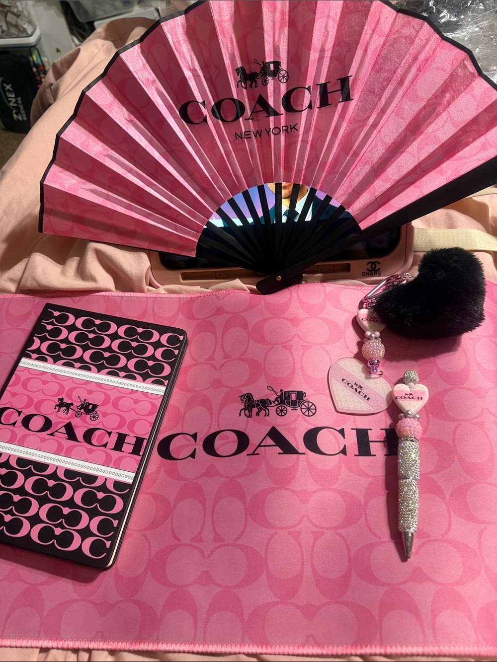 Pink & black journal w/ matching pen, keychain, desk mat and fan.